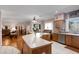 Spacious kitchen and living area with wood cabinets, island with seating, and sliding doors to the outside at 16450 E Avenue Of The Fountain -- # 47, Fountain Hills, AZ 85268