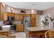 Well-equipped kitchen featuring stainless steel appliances, wood cabinets, and a central island with barstool seating at 16450 E Avenue Of The Fountain -- # 47, Fountain Hills, AZ 85268