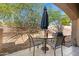 Relaxing covered patio with shade umbrella, table, and chairs to enjoy outdoor space at 16450 E Avenue Of The Fountain -- # 47, Fountain Hills, AZ 85268