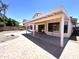 Enclosed backyard featuring a covered patio area, brick pavers, and block wall fencing at 1704 E Redfield Rd, Gilbert, AZ 85234