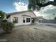 Backyard featuring a covered patio and an extended patio area with pavers and desert landscaping at 1704 E Redfield Rd, Gilbert, AZ 85234