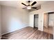 Empty bedroom featuring wood-look floors, one window and a closet at 1704 E Redfield Rd, Gilbert, AZ 85234