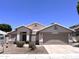 Charming single-story home with a well-maintained front yard and a two-car garage at 1704 E Redfield Rd, Gilbert, AZ 85234