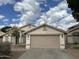 Charming single-story home featuring a neutral color palette, a two-car garage and minimal landscaping at 1704 E Redfield Rd, Gilbert, AZ 85234
