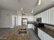 Bright kitchen featuring white cabinets, stainless steel appliances, and a large island with a double sink at 1704 E Redfield Rd, Gilbert, AZ 85234