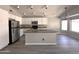 Spacious eat-in kitchen with white cabinets, stainless steel appliances, and granite countertops at 1704 E Redfield Rd, Gilbert, AZ 85234
