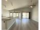 Open living space adjacent to the kitchen with a granite countertop island, large windows, and sliding doors at 1704 E Redfield Rd, Gilbert, AZ 85234