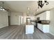 Open concept living space with a kitchen island and stainless steel appliances at 1704 E Redfield Rd, Gilbert, AZ 85234