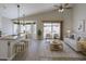 Bright, open living room with dining area, modern furnishings, and sliding door access to the backyard at 1704 E Redfield Rd, Gilbert, AZ 85234