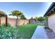 Spacious backyard with artificial turf, mature trees, and a charming shed for extra storage at 17211 N 58Th St, Scottsdale, AZ 85254