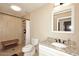 Bathroom featuring granite countertop, tile shower, toilet, and wooden bench at 17211 N 58Th St, Scottsdale, AZ 85254