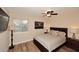 Cozy bedroom featuring a queen size bed, ceiling fan, and a window at 17211 N 58Th St, Scottsdale, AZ 85254