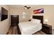 Bedroom featuring a plush queen-sized bed, dark furniture, and wood flooring at 17211 N 58Th St, Scottsdale, AZ 85254