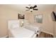 Well-lit bedroom featuring two twin beds, ceiling fan, and a window at 17211 N 58Th St, Scottsdale, AZ 85254