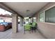 Inviting covered patio with stylish seating, hot tub, and view to backyard oasis at 17211 N 58Th St, Scottsdale, AZ 85254