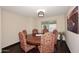 Cozy dining room featuring a hardwood floor, a round table, and stylish seating at 17211 N 58Th St, Scottsdale, AZ 85254