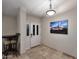 Welcoming entryway with decorative front door, tile flooring, and elegant light fixture at 17211 N 58Th St, Scottsdale, AZ 85254