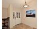 Welcoming entryway with decorative front door, tile flooring, and elegant light fixture at 17211 N 58Th St, Scottsdale, AZ 85254