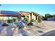 Charming home featuring a tiled roof, solar panels, a two-car garage, and desert landscaping at 17211 N 58Th St, Scottsdale, AZ 85254