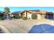 Charming home featuring a tiled roof, solar panels, a two-car garage, and desert landscaping at 17211 N 58Th St, Scottsdale, AZ 85254
