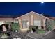 Charming home featuring a tiled roof, solar panels, and a well-manicured front yard at night at 17211 N 58Th St, Scottsdale, AZ 85254