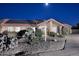 Charming home featuring a tiled roof, solar panels, and desert landscaping at night at 17211 N 58Th St, Scottsdale, AZ 85254