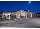 Charming home featuring a tiled roof, solar panels, long driveway, and desert landscaping at night at 17211 N 58Th St, Scottsdale, AZ 85254