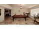 Inviting game room with pool table, travertine floors, and a chandelier at 17211 N 58Th St, Scottsdale, AZ 85254