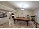 Travertine floor game room featuring a pool table and comfortable bar seating at 17211 N 58Th St, Scottsdale, AZ 85254