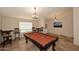 Bright game room with travertine floors, pool table, and picture window at 17211 N 58Th St, Scottsdale, AZ 85254