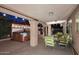 Covered outdoor patio with hot tub, string lights, patio furniture, and green plants at 17211 N 58Th St, Scottsdale, AZ 85254