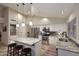 Bright kitchen features stainless appliances, white cabinets, island, and stone backsplash at 17211 N 58Th St, Scottsdale, AZ 85254