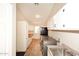 Functional laundry room with ample storage, stainless steel appliances, and a convenient utility sink at 17211 N 58Th St, Scottsdale, AZ 85254