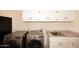 Modern laundry room with stainless steel washer and dryer, cabinets, and a utility sink for convenience at 17211 N 58Th St, Scottsdale, AZ 85254
