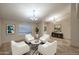 Bright living room featuring white chairs, a zebra rug, and an elegant chandelier at 17211 N 58Th St, Scottsdale, AZ 85254