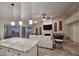 Living room with kitchen view, fireplace, and lots of seating at 17211 N 58Th St, Scottsdale, AZ 85254