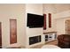 Fireplace with television and decor with adjacent seating at 17211 N 58Th St, Scottsdale, AZ 85254