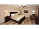Comfortable main bedroom features wood floors, ceiling fan, and a sitting chair at 17211 N 58Th St, Scottsdale, AZ 85254