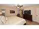 Well-lit main bedroom showcases a TV, barn door, and wood-look flooring at 17211 N 58Th St, Scottsdale, AZ 85254
