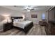 Spacious main bedroom featuring wood floors, ceiling fan, and a comfortable sitting area at 17211 N 58Th St, Scottsdale, AZ 85254