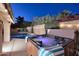 Backyard view of the refreshing pool, hot tub, string lights, and desert landscaping at 17211 N 58Th St, Scottsdale, AZ 85254