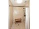 Walk-in shower with a wooden bench and bronze shower fixtures at 17211 N 58Th St, Scottsdale, AZ 85254