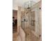 Modern tiled shower featuring glass surround, bench, and bronze fixtures at 17211 N 58Th St, Scottsdale, AZ 85254
