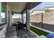 A beautiful outdoor patio with a gray block wall, providing shade, and showcasing outdoor seating at 17320 W Daley Ln, Surprise, AZ 85387