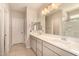 Elegant bathroom with double vanity, sleek countertops, and a large mirror at 17320 W Daley Ln, Surprise, AZ 85387