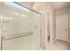 Modern bathroom with a glass-enclosed shower and tiled floors, complemented by neutral wall paint at 17320 W Daley Ln, Surprise, AZ 85387