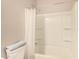 Clean bathroom with a shower-tub combination and a toilet with a towel on the tank at 17320 W Daley Ln, Surprise, AZ 85387