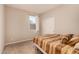 Comfortable bedroom showcasing a bed, carpet floors, and a window for natural light at 17320 W Daley Ln, Surprise, AZ 85387