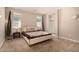 Cozy bedroom featuring a queen-sized bed and natural light from multiple windows at 17320 W Daley Ln, Surprise, AZ 85387