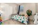 Cozy bedroom featuring a comfortable bed with playful dinosaur themed bedding and carpet flooring at 17320 W Daley Ln, Surprise, AZ 85387
